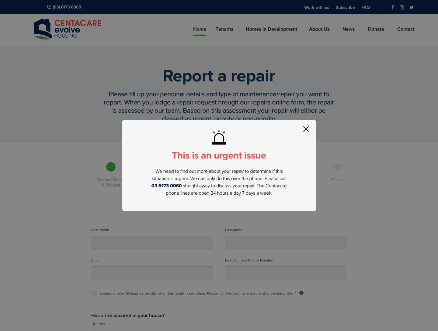 The Report a repair form, greyed out behind a dialog headed 'This is an urgent issue', which gives the 24-hour phone number and states the lines are open every day.